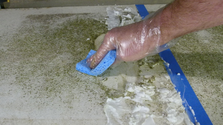 Sponge wiping quartz countertop 