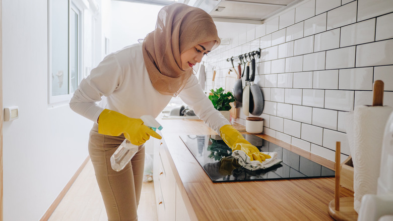woman cleaning stovetop
