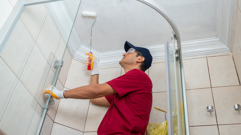 man paints the bathroom