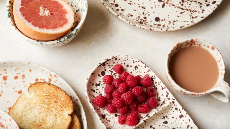 Splatterware dining set in various colors holding breakfast foods