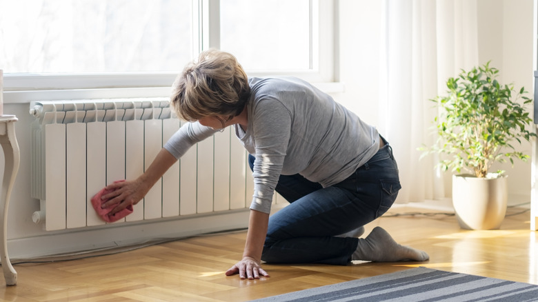 Person kneeling and cleaning