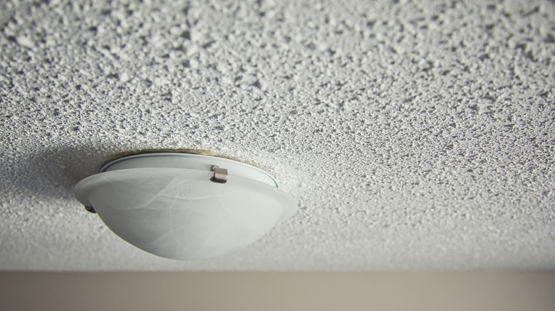 closeup of popcorn ceiling with a light fixture