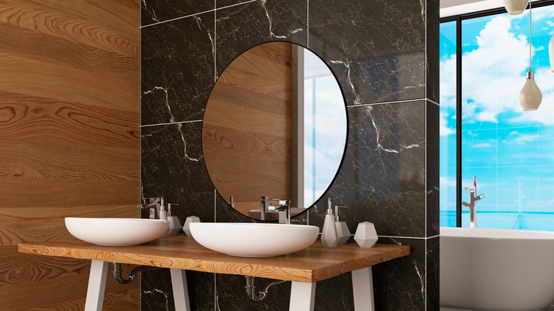 Black marble accent wall incorporated into a bathroom design