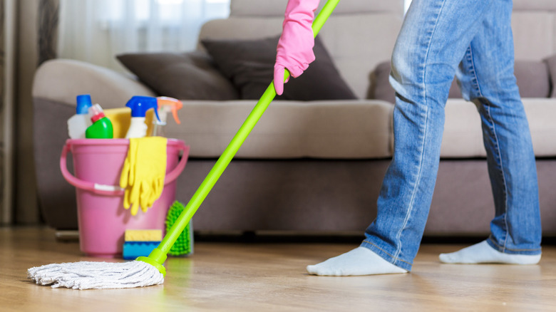 person cleaning wood floors