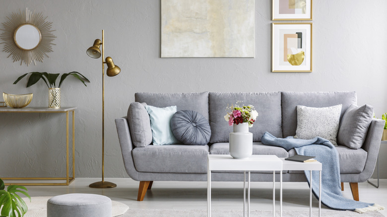Grey sofa with gold accents