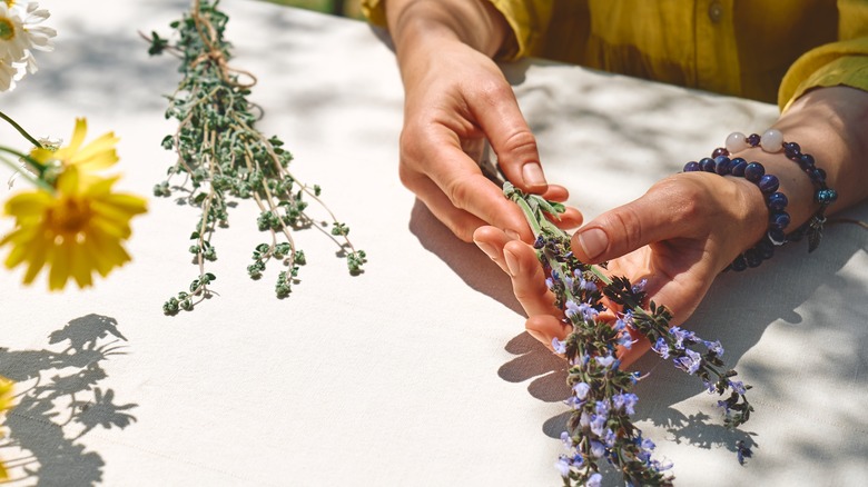 woman holding sage flowers