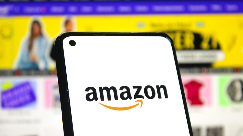 Amazon app open on phone with shopping page in background