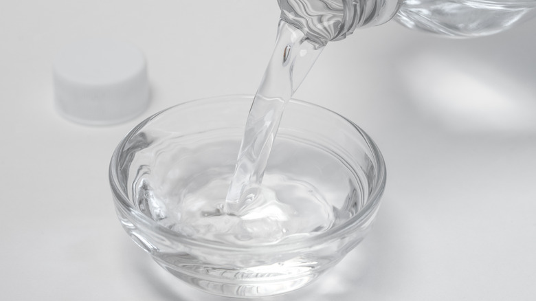 Pouring vinegar in bowl