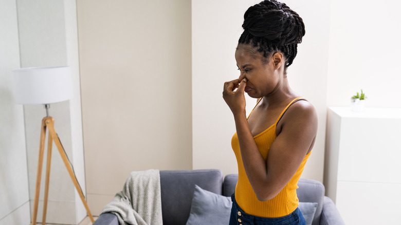 woman smelling something bad