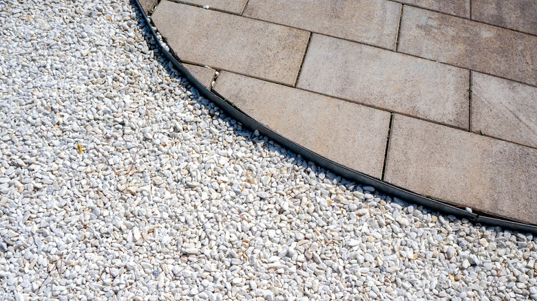 Metal landscape edging separates pavers and gravel