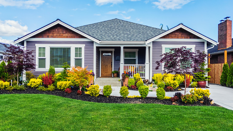 A view of a house with a beautifully landscaped front yard