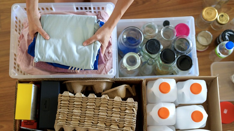 Person organizing household items into assorted bins