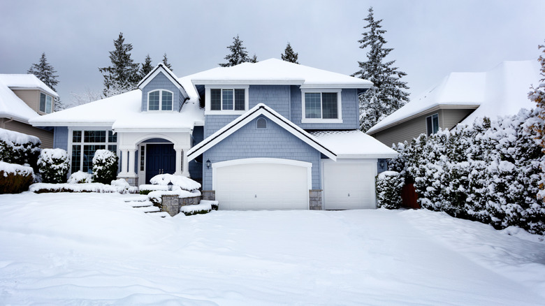 house with snow-filled driveway