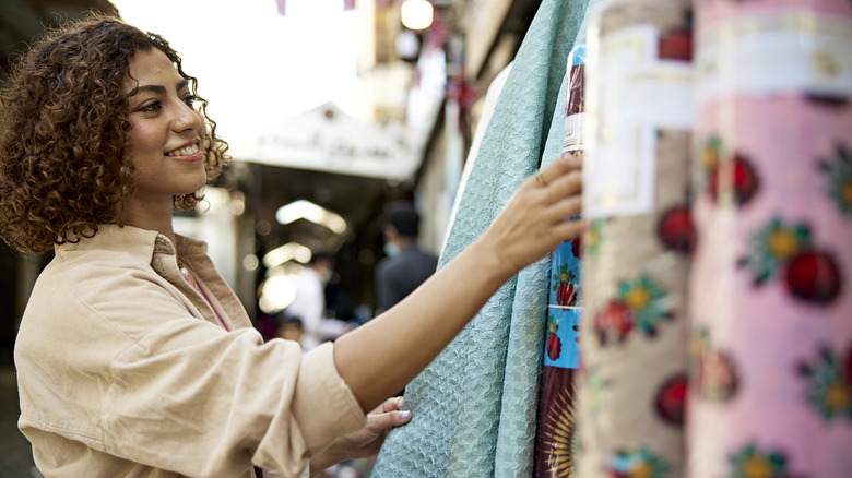 Woman browsing through different fabrics