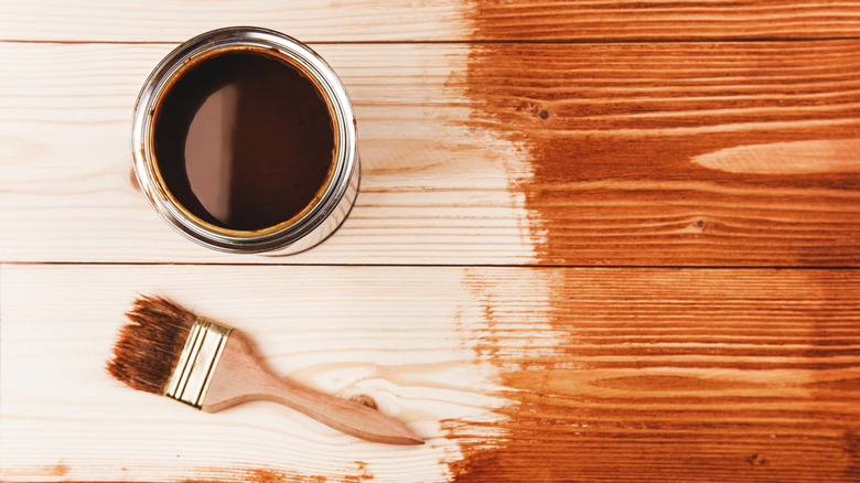 Closeup of wood stain and brush