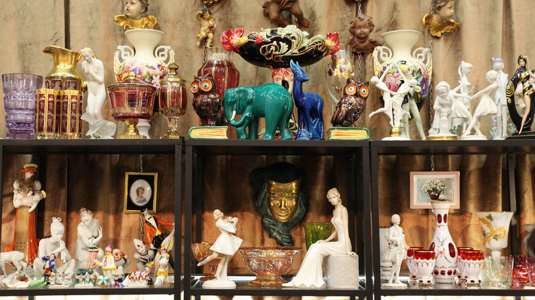 Shelves in a second-hand store are lined with glass and porcelain figurines.