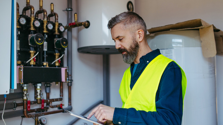 A technician inspecting a water heater system