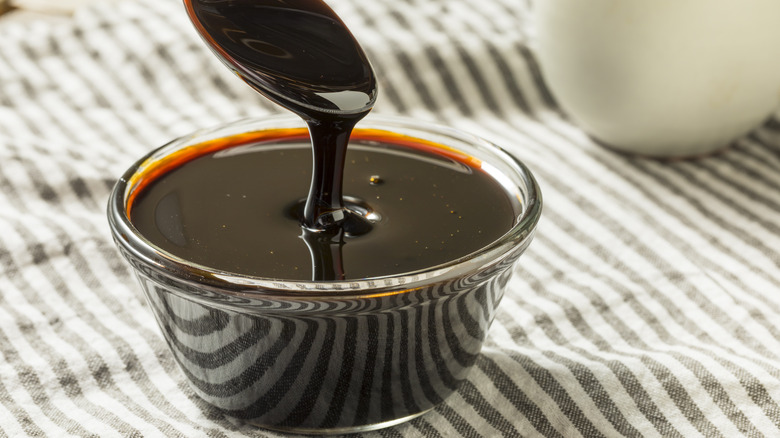 Spoon pouring molasses in bowl