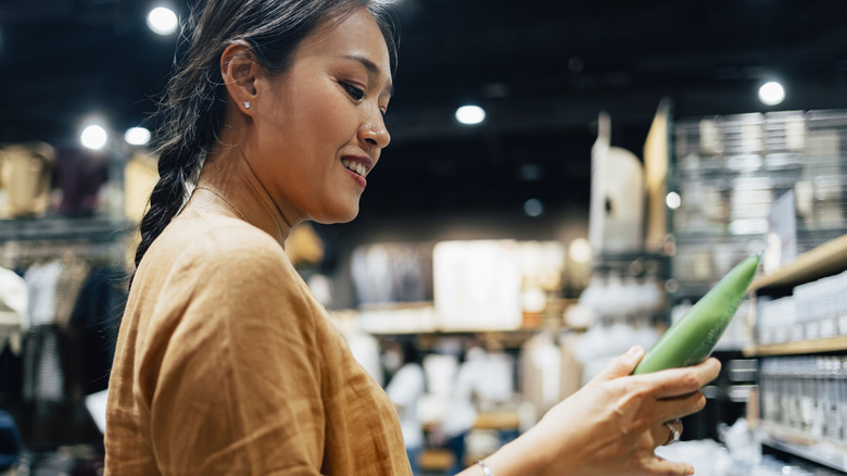A woman is looking at a product in a store