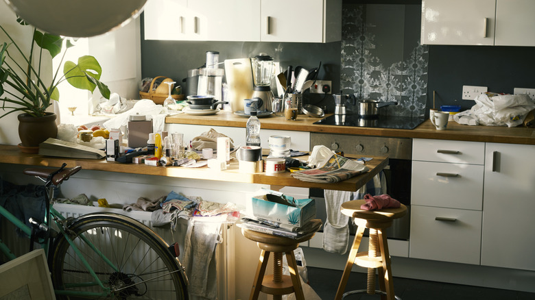 A kitchen with various items cluttering the counters
