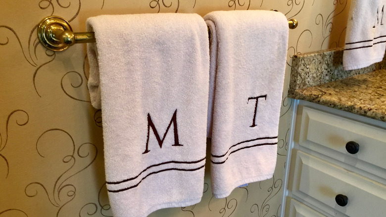 Two monogrammed towels in a bathroom