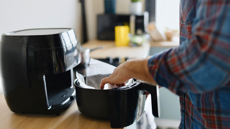 Man opening air fryer