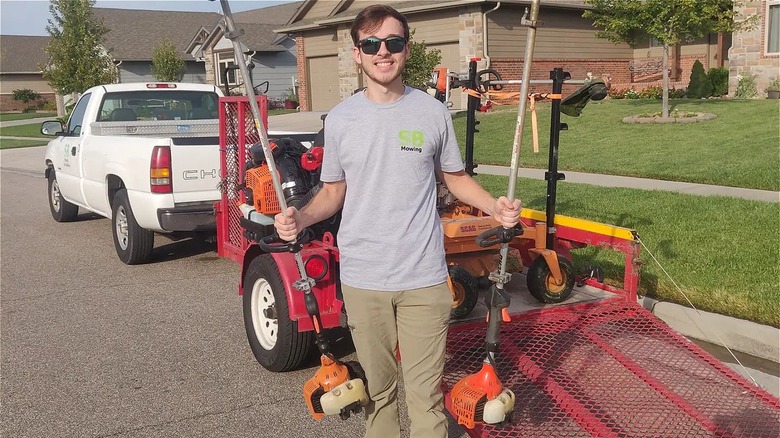 Spencer holding lawn equipment