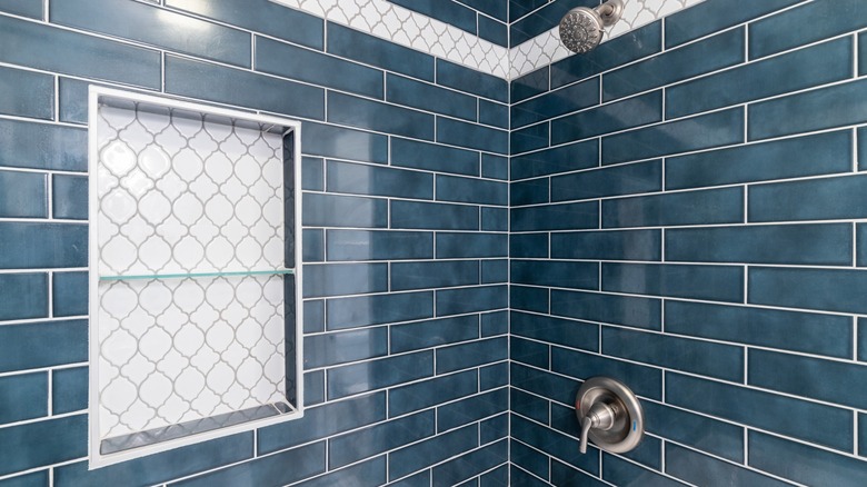 Blue shower with white tile niche