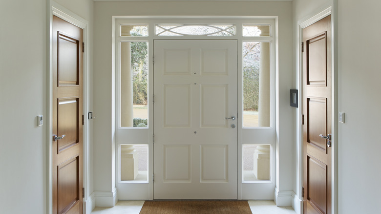 Plain white interior front door with sidelights