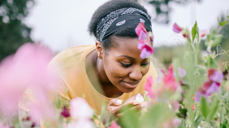 A woman is gardening in a flower garden