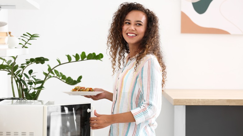 Woman using microwave