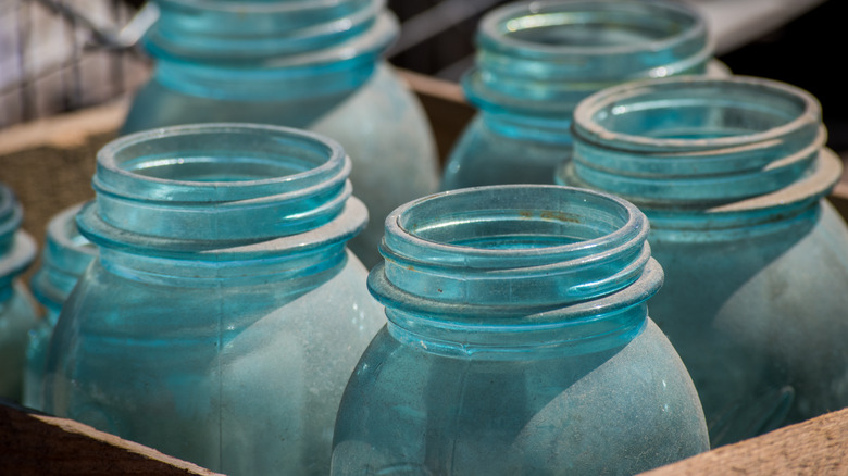 Dusty aqua screw-top Mason jars in a crate