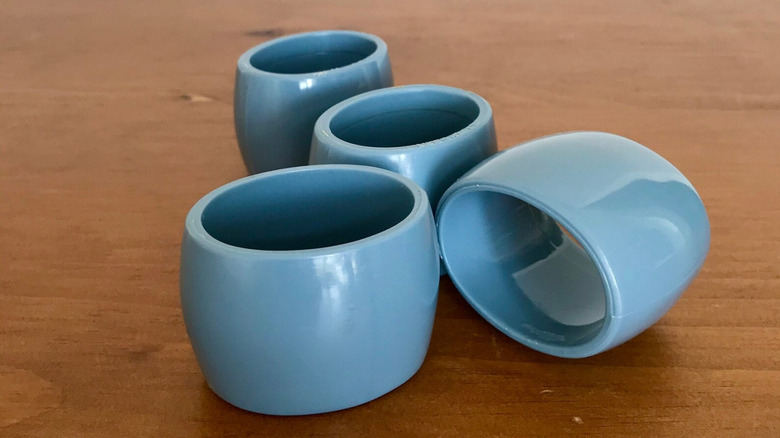 Four opaque lucite napkin rings.