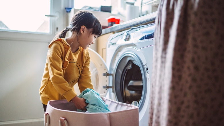 Young girl doing laundry