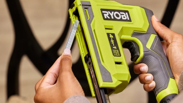 Person loading staples into the 4-in-1 Ryobi stapler
