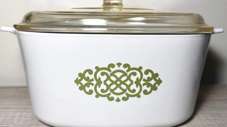 The CorningWare Shell Oil Macrame pattern in green on a large casserole dish with lid