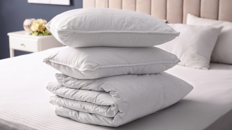 Bed pillows stacked with comforter
