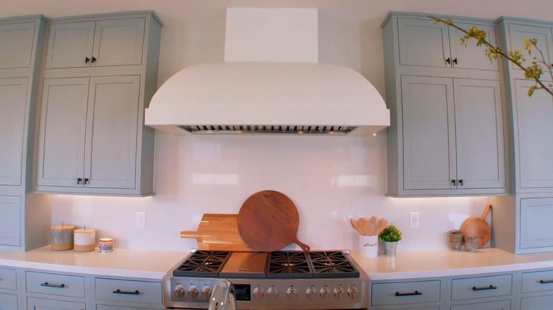 A white plaster vent hood in a modern kitchen.