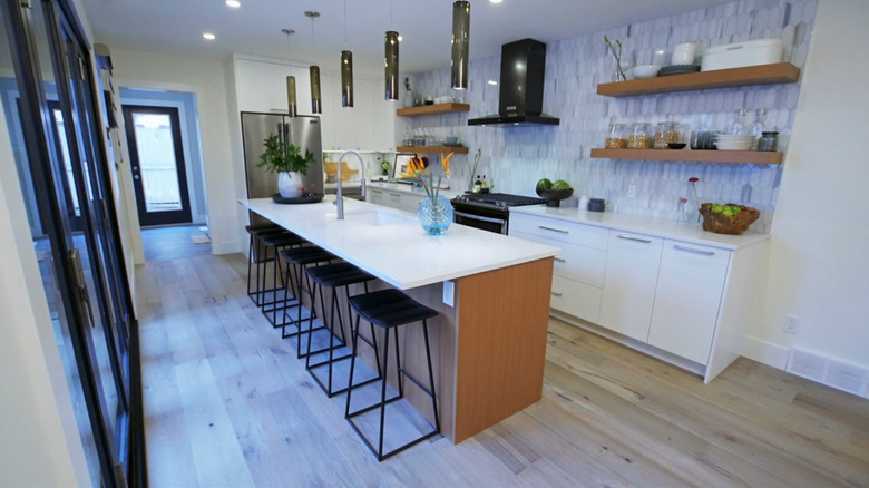A modern kitchen with a large quartz island.