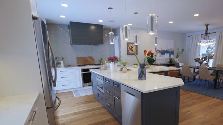 A large kitchen with a blue herringbone tile backsplash.