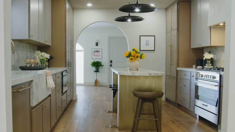 A kitchen with wood cabinets and integrated appliances.