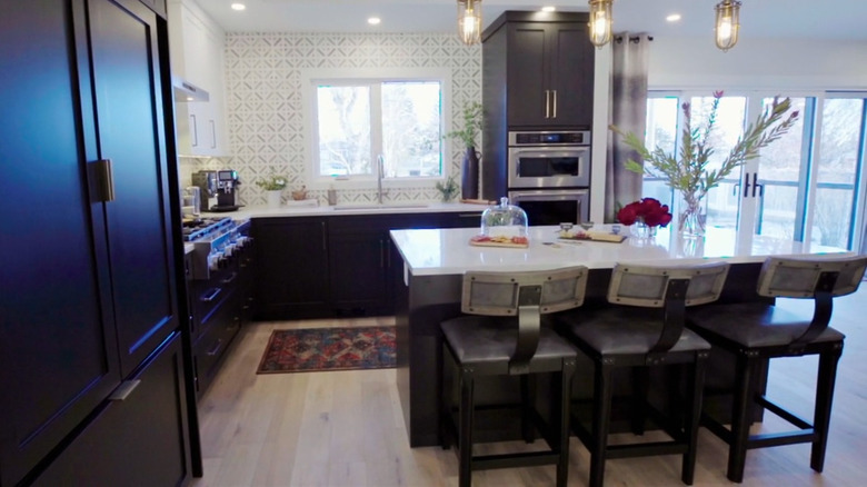 A modern kitchen with a view of the backyard