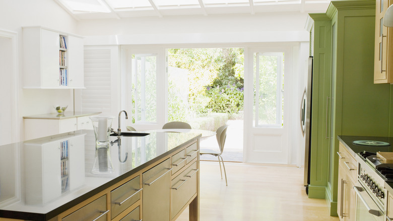 A bright kitchen with green accents.