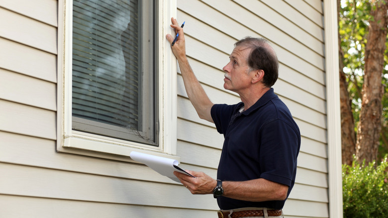 Home inspector checking windows on a new house