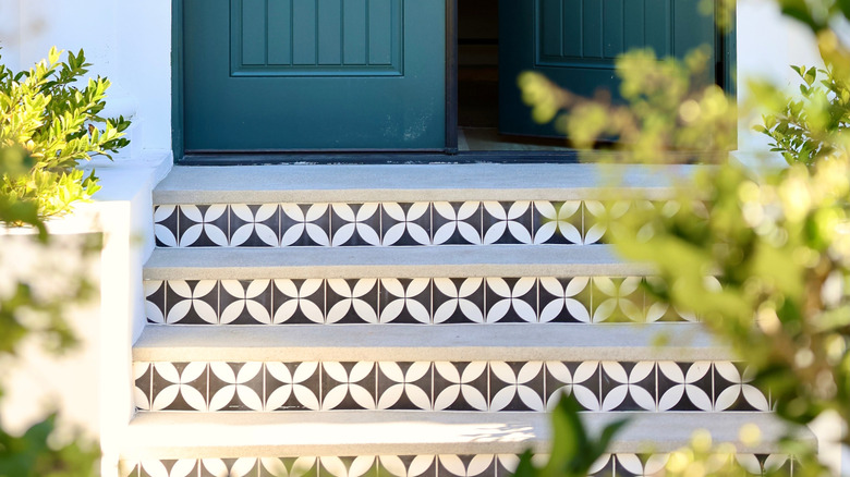 Decorative tiles on front porch steps.