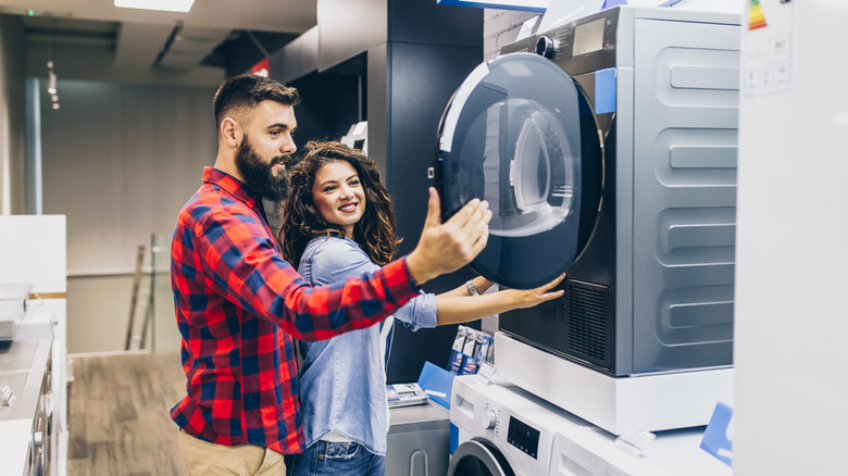 Couple shopping for washing machine