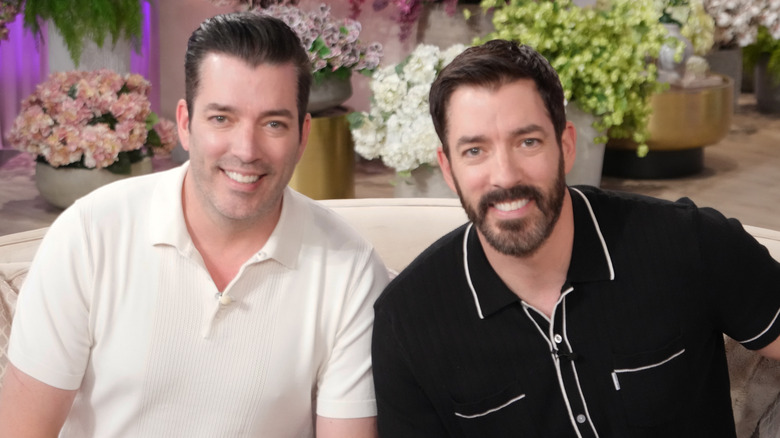The Property Brothers smiling on a TV interview talk show