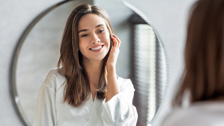 woman using bathroom mirror