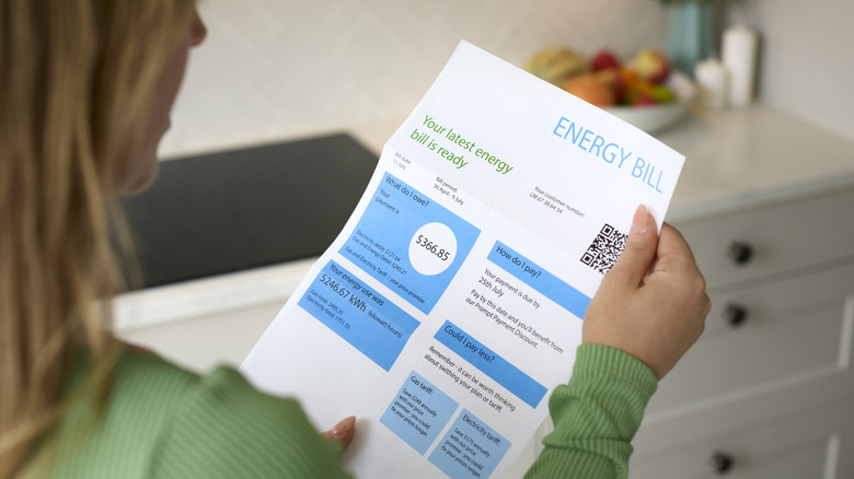 Woman holding an electricity bill