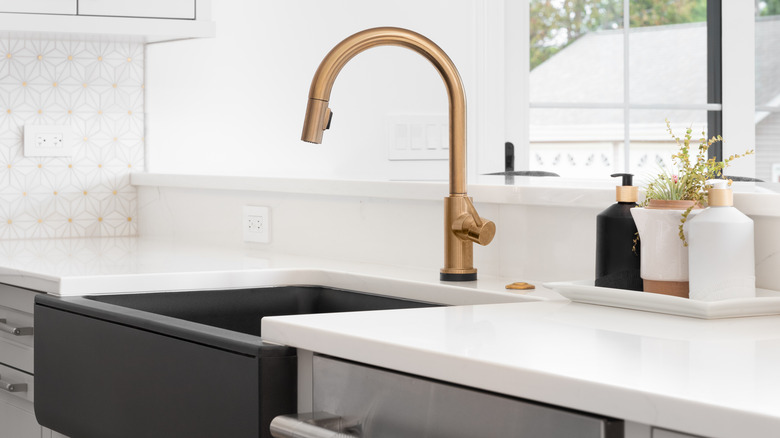 Gold faucet in kitchen